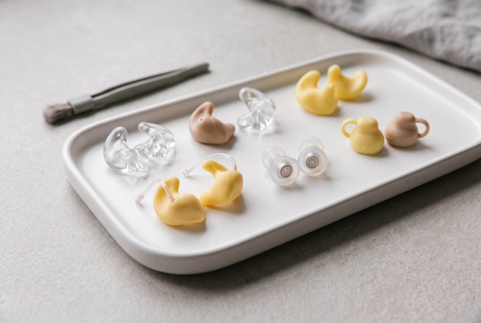 Custom ear molds and earplugs on a tray